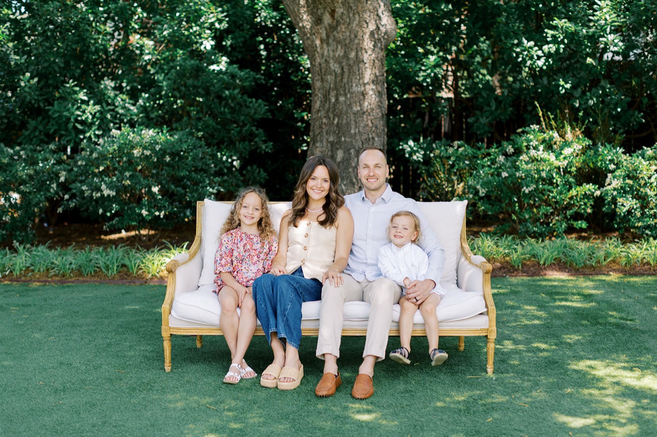 Anders with his wife and two children sitting together in a garden